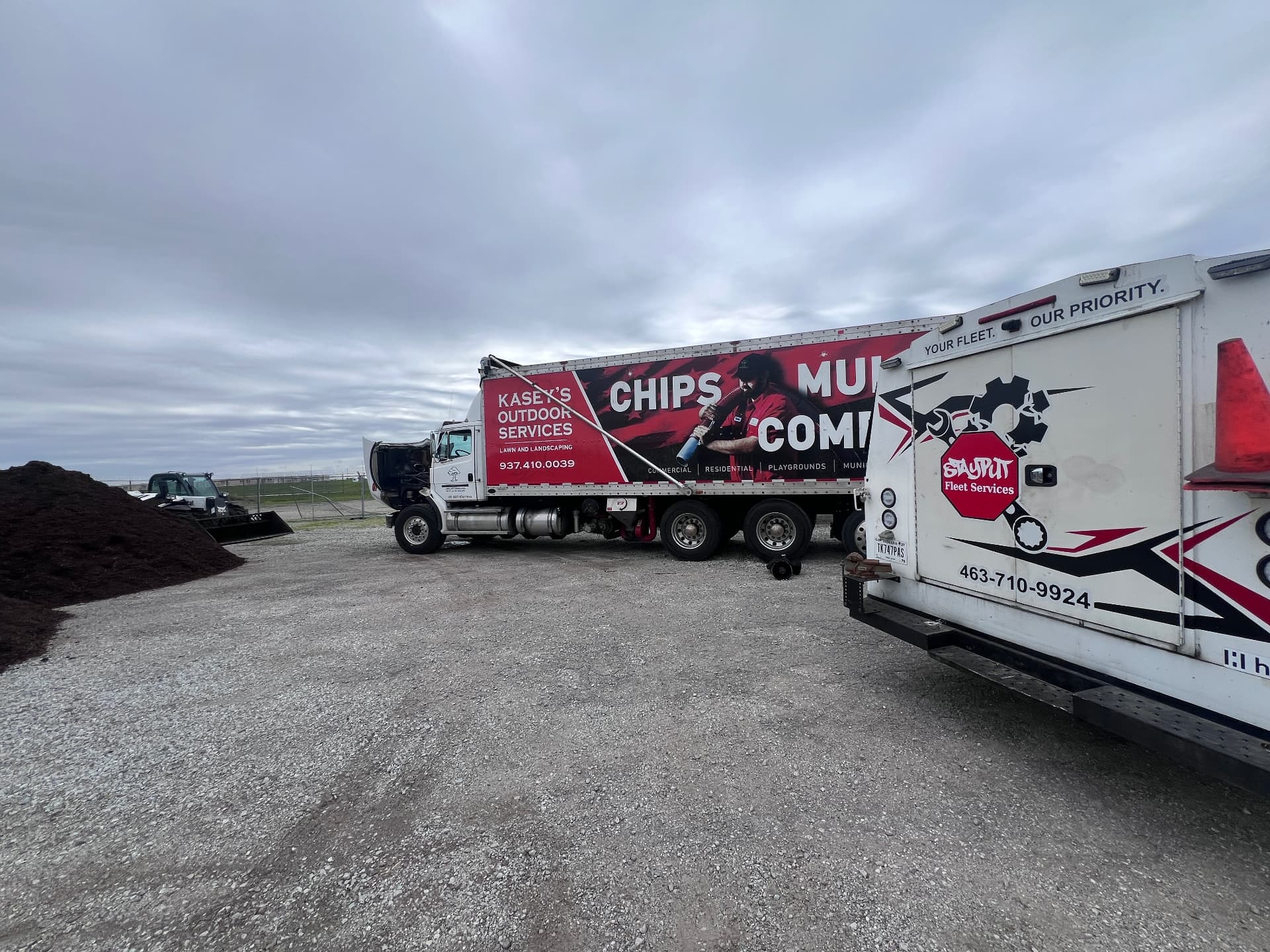 Kasey's Outdoor Services chip truck with hood open next to StayPut mobile unit